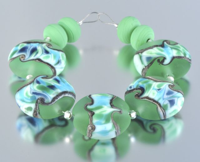 Green lentil beads with a patterned band